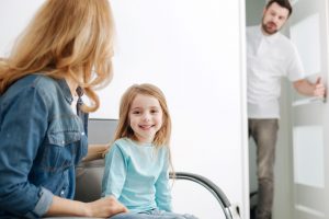 a young child sitting waiting for the dentist