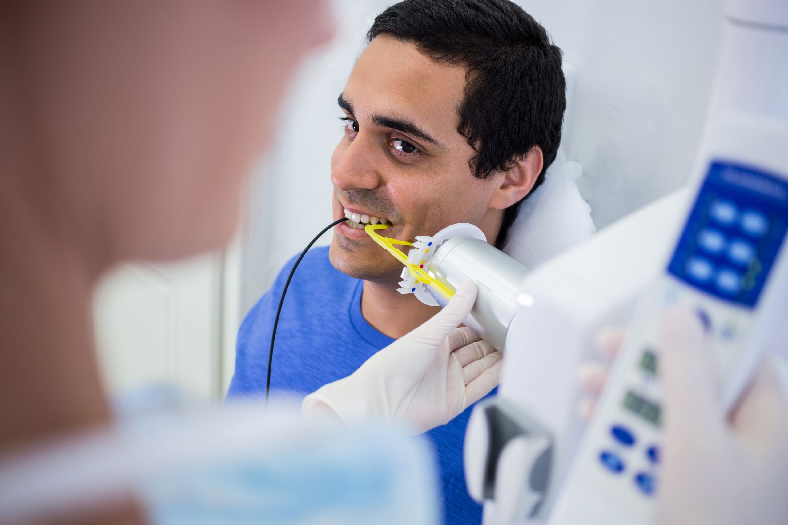 Dentist taking x-ray of patients teeth at clinic