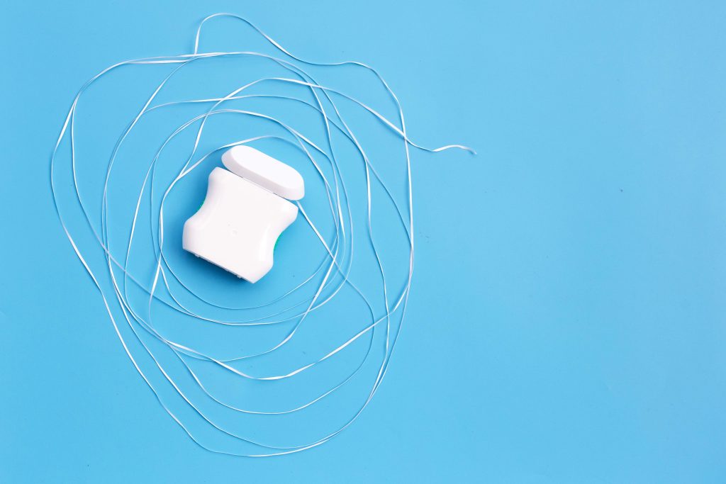 Dental floss on blue background.