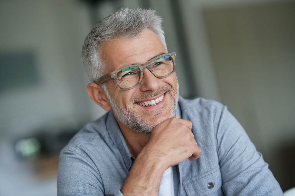 un homme senior souriant aux dents blanches