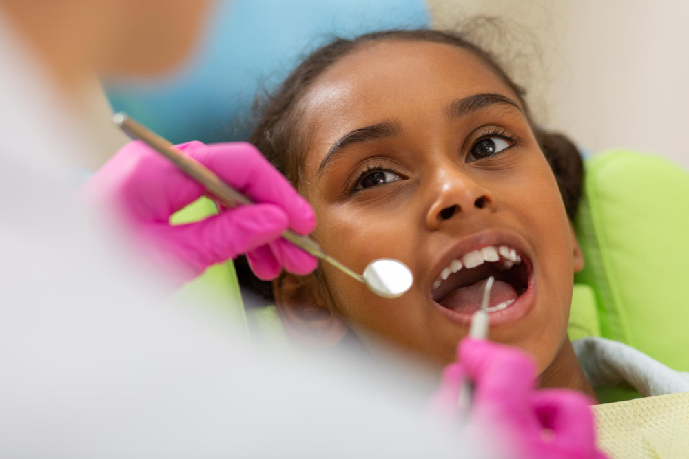 young girl open mouth at the dentist for a treatment on the south shore of montreal