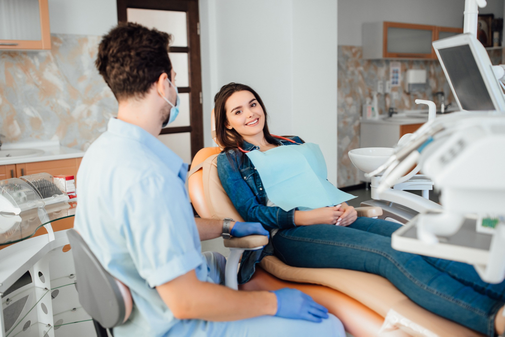 young woman smiling on chair at the dentist on south shore of montreal