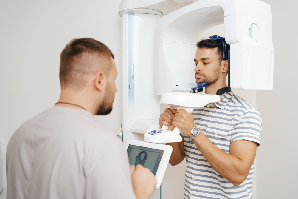 man in machine at dentist boucherville getting teeth x-rays